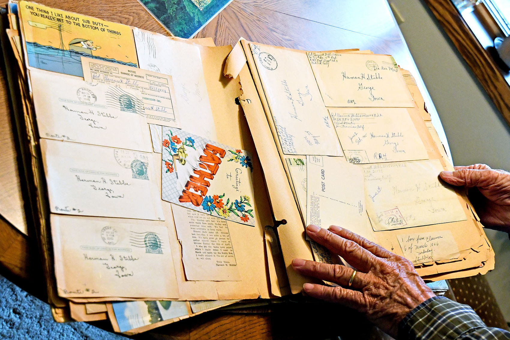Clarence Stubbe opens book of letters